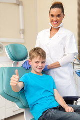 little boy thumb up in dentist office