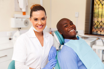 young female dentist and african patient