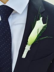 Calla lily flower on groom's jacket