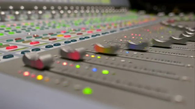 Automated faders used for mixing sound