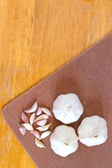 Garlic on wooden background. Selective focus. 