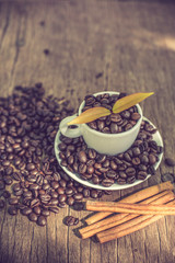 Coffee cup and coffee bean on a wooden table and Coffee plant.vi