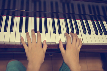 Girl's hands on the keyboard of the piano : Vintage filter