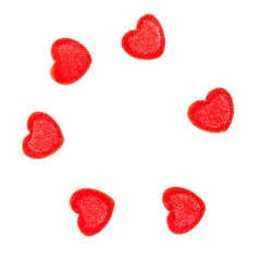 Red heart-shaped sugar sprinkles on white background