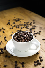 Cup full of coffee beans on the table