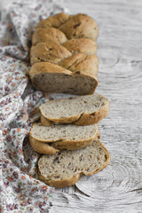 Fototapeta na wymiar whole grain bread with pecans on a light wooden background