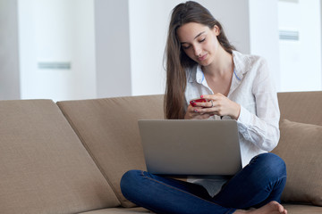 relaxed young woman at home working on laptop computer