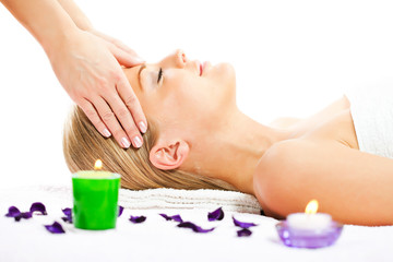Obraz na płótnie Canvas Young woman having forehead massage on spa treatment