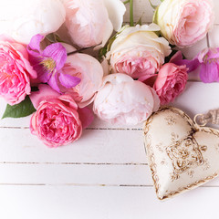 Sweet pastel roses, clematis flowers and decorative heart