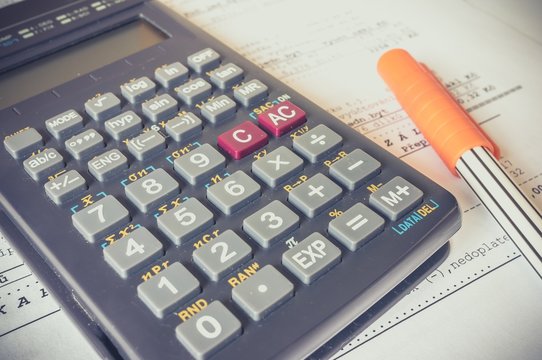 Business composition of bills, calculator, pen and various statistics