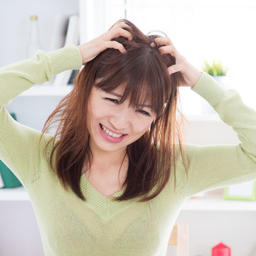 Asian Woman Scratching Itchy Head