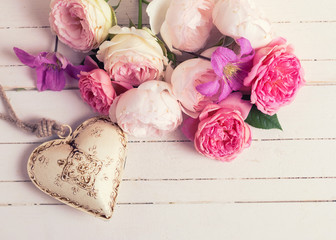 Sweet pastel roses, clematis flowers and decorative heart