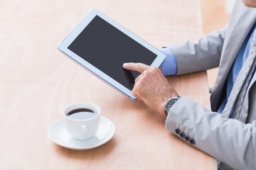 Fototapeta na wymiar Concentrating businessman using a tablet