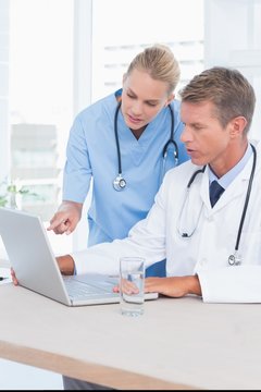 Doctor and nurse working with computer 
