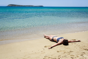 Fototapeta na wymiar Girl relaxing on the beach