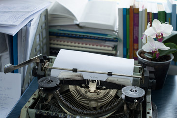 Vintage typewriter on a table with books