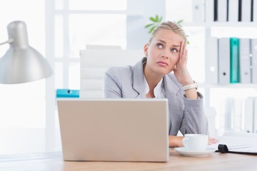 Frustrated businesswoman with head in hand