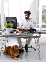 Businessman working at pet-friendly workplace