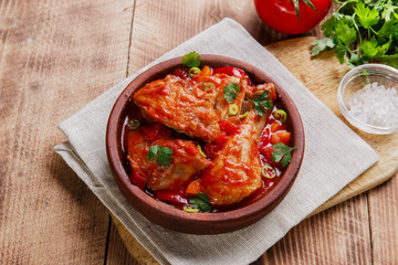 chicken in tomato sauce in a bowl chakhokhbili