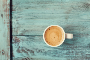 Cup of fresh coffee on vintage wooden blue table