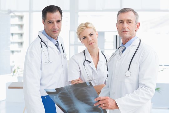 Concentrated doctors looking at camera 