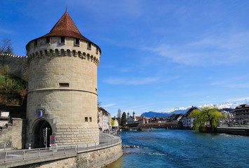 Fototapeta na wymiar View to reuss river embankment with round tower. Lucern. Switzerland. 