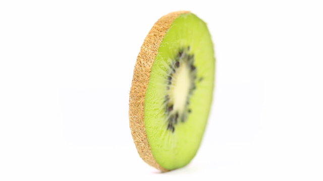 Closeup shot of a fresh kiwi fruit slice rotating in a loop