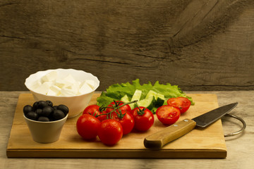 Home cooking summer Greek salad on wooden background