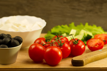 Home cooking summer Greek salad on wooden background