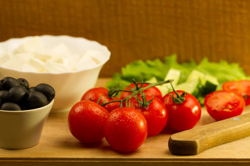 Home cooking summer Greek salad on wooden background