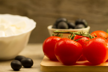 Home cooking summer Greek salad on wooden background