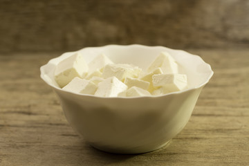 Feta is a traditional Greek cheese on wooden background