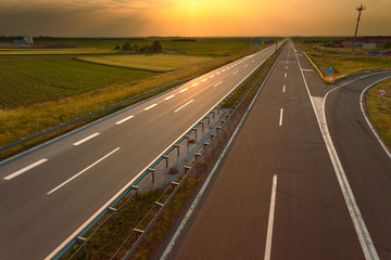 Driving on an empty motorway at sunset