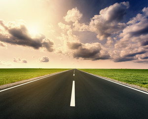 Driving on open asphalt road at idyllic sunny day