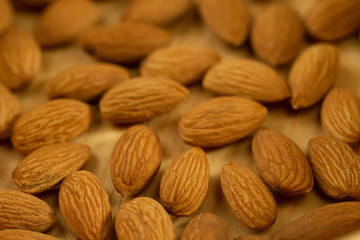 peeled almonds on wooden background. For vegetarians