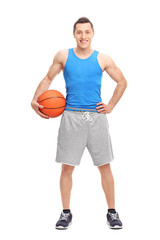 Young male athlete holding a basketball