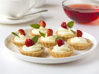 Many cakes, cupcakes with fresh fruits (strawberries)
