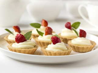 Many cakes, cupcakes with fresh fruits (strawberries)