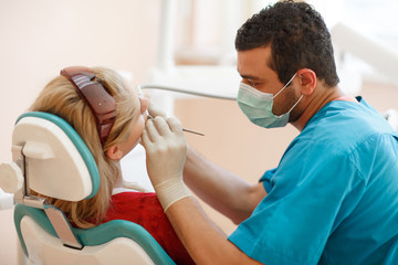 Dentist and female pacient at dental clinic tooth care