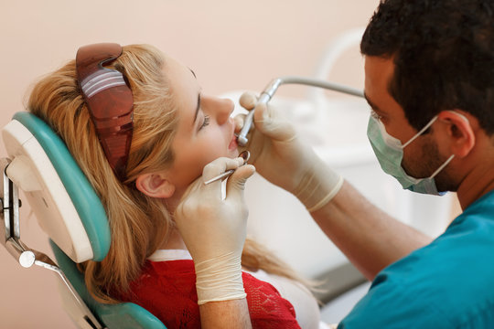 Dentist and female pacient at dental clinic tooth care