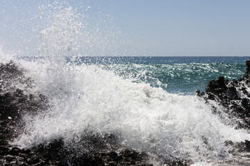 A big wave breaks against the rocks on falasarna beach, Crete.