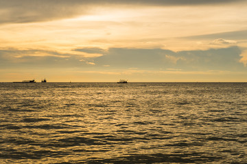 Seascape with scenic sunset and boats