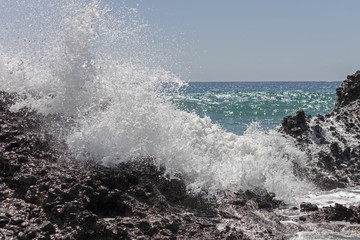 A big wave breaks against the rocks on falasarna beach, Crete.