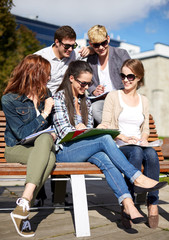 group of happy students with notebooks at campus