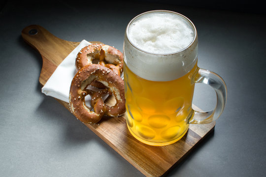 2 Brezn/Pretzels on a breadboard with beer 2