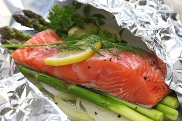 fresh salmon with asparagus in foil paper, ready for cooking