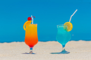 Summer drinks cocktails with blur beach on background