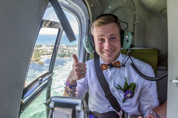 happy groom riding helicopter