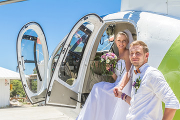 happy wedding couple bride and groom riding helicopter © Alena Yakusheva
