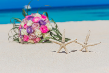 Fototapeta na wymiar wedding rings on star fish, beach wedding concept, outdoor weddi